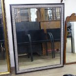 A modern black and gilt-framed bevel-edge wall mirror, 105cm x 88cm