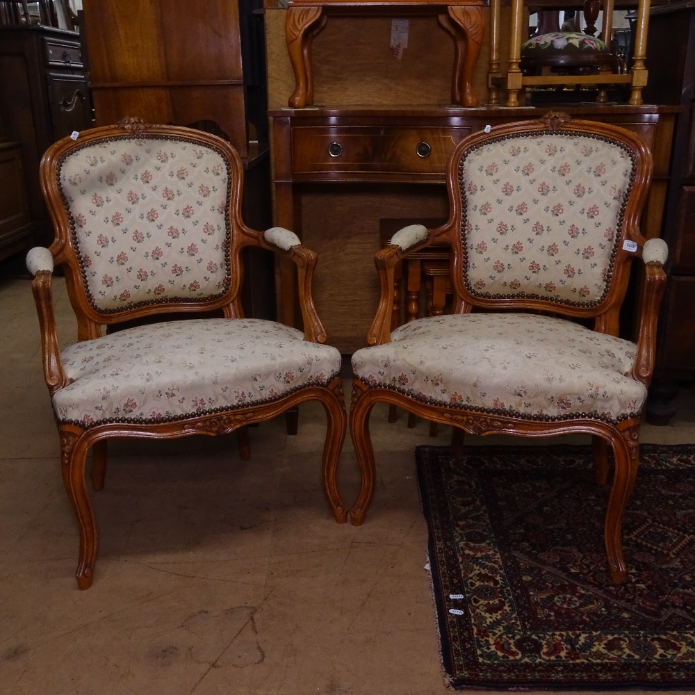 A pair of French carved beech-framed and upholstered open bedroom chairs