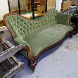 A Regency mahogany-framed and button-back upholstered settee of serpentine form, on turned legs,