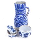 An Oriental blue and white painted jug, 20cm, a pot with floral decoration, salt pot etc (4)