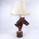 A woodgrain effect horse-head table lamp, with matching shade, 68cm overall
