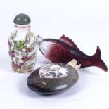 A Chinese amethyst glass fish snuff bottle, an Oriental horn and bone bottle, and another
