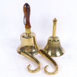 A brass bell with turned wood handle, 27cm, a smaller bell, and 2 brass shoe horns