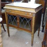 An early 20th century oak cabinet, with cutlery drawer, glazed cupboards under, on tapered legs,