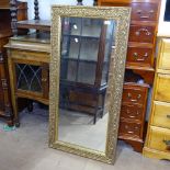 A modern embossed gilt-framed rectangular wall mirror, 57cm x 116cm