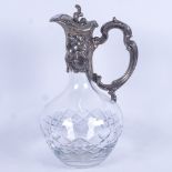 An Art Nouveau cut-glass Claret jug, with embossed white metal mounts, height 27cm