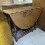 An Antique oak oval gateleg table, on baluster turned legs, W98cm