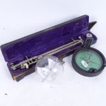 A cased Griffin & George compass and plastic globe, and cased instrument by Crosby Steam Gage &
