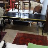 An ebonised and gilded console table of rectangular form, with applied carved decoration, on