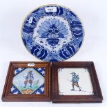 A faience tin-glaze plate with painted floral design, 23cm, and 2 framed tiles