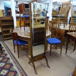 A 1930s bevel-edge cheval mirror on oak stand