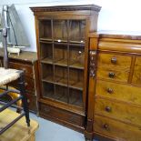 A Georgian style hardwood bookcase, with carved lattice glazed door, and drawer under, W85cm,