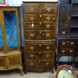 An early 20th century cross-banded mahogany chest on chest, of bow-front form, on bracket feet,