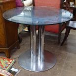 A 1970s glass dining table, on 4 chrome pillars with stainless steel disc base, in the manner of