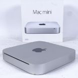 An Apple Mac Mini computer, model no. A1347, working order, boxed with discs but no cables