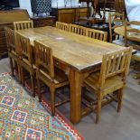 A large rectangular refectory pine dining table, square chamfered legs and flat H-shaped