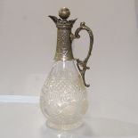 An Edwardian cut-glass Claret jug, with scrolled and embossed silver plated mount
