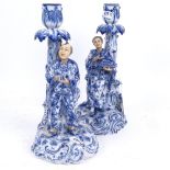 A pair of 19th century blue and white porcelain figural candlesticks, depicting Chinese figures,