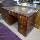 A Victorian oak twin-pedestal writing desk with fitted drawers, W123cm, H73c, D60cm, knee-hole