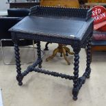 An Antique oak clerk's writing desk, with raised gallery, rising slope and barley twist supports and