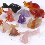 A group of carved and polished hardstone animals, including malachite lion, amethyst and rose quartz