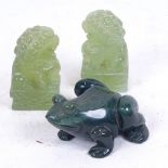 A pair of carved jadeite Dogs of Fo, and a green agate frog, length 6cm (3)