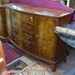 A reproduction cross-banded mahogany bow-front sideboard, with fitted drawers and cupboards, on