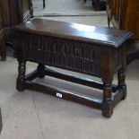 A 20th century style joined oak coffer of small size, with chip carved panels, on splayed turned...