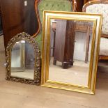 A pierced composite arch-top framed wall mirror, H58cm, and a gilt-framed rectangular bevel-edge