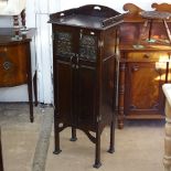 An Art Nouveau walnut music cabinet, with raised stylised gallery, 2 panelled cupboard doors with