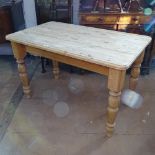 A stripped pine rectangular farmhouse table, on turned baluster legs, L122cm, H77cm, D72cm