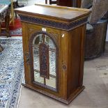 A Victorian mahogany hanging cabinet, with arch-top bevel-glazed panel door, W56cm, H76cm, D31cm