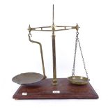 An Avery brass pan balance scale, on mahogany base, height 50cm