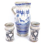 A large Spanish blue and white glazed pottery water flagon, and a pair of Dutch pottery beakers,