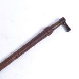 A 19th century riding crop with brass mud scraper knop, overall length 83cm