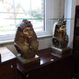 A pair of Tutankhamun head coffee tables, with circular glass tops, W47cm, H54cm