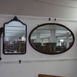 An Edwardian oval reeded-framed wall mirror, and a Georgian style mahogany bevel-edge wall mirror (