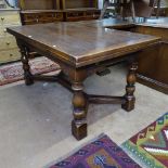 A rectangular oak refectory draw leaf dining table, on Y-shaped stretcher and baluster turned