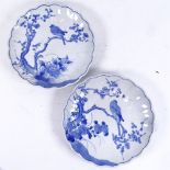 A pair of Japanese blue and white ceramic lobed plates, bird in tree decoration, diameter 22cm