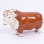 A mustard shop slip glazed terracotta Bull Bank money box, possibly Coleman's, length 18cm