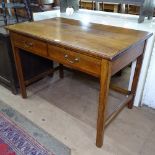 An early 20th century rectangular oak writing desk, 2 frieze drawers, raised on chamfered legs,