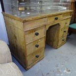 An early 20th century pine writing desk with fitted drawers, W125cm, H82cm, D60cm