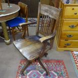 An early 20th century oak swivel desk chair