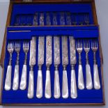 A suite of dessert cutlery for 12 people, with floral engraved blades and mother-of-pearl handles,