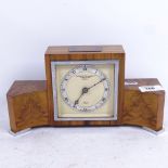 An Elliott walnut-cased clock retailed by Goldsmiths & Silversmiths Company, with plaque dated 1952,