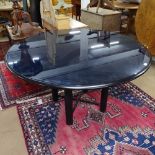 A 1980s post-modern Ligne Roset dining table, a circular saucer-shape top with inset blue