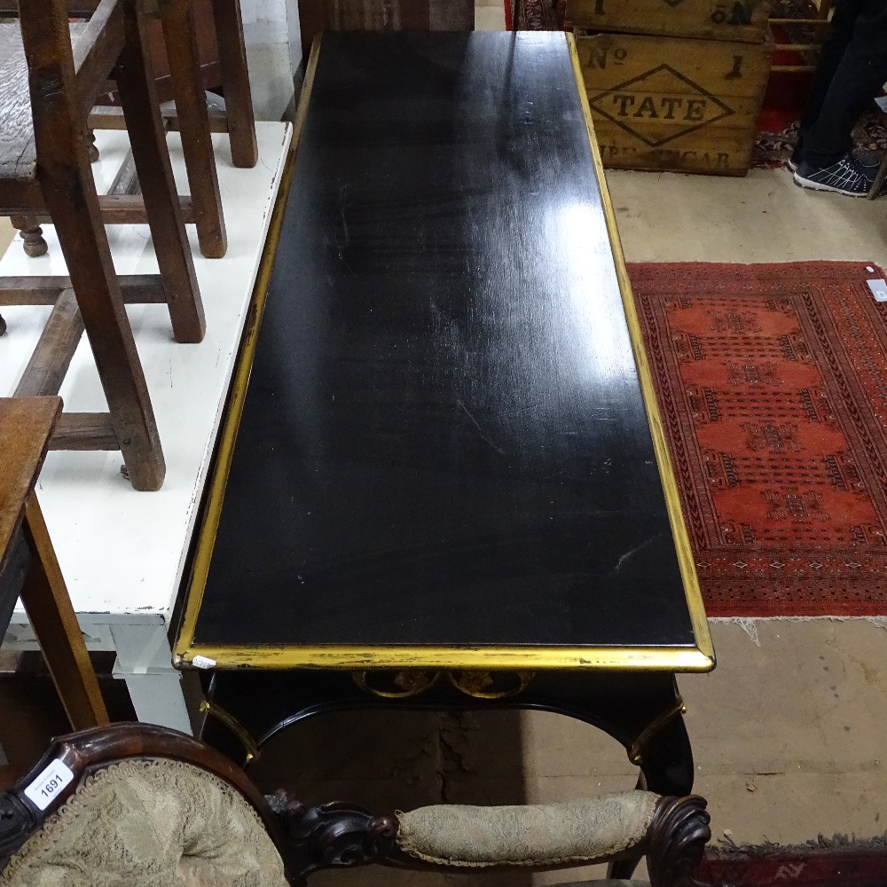An ebonised and gilded console table of rectangular form, with applied carved decoration, on - Image 2 of 2