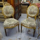 A pair of carved gilt and upholstered salon chairs, with fluted legs