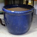 A large blue glazed terracotta garden pot