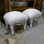 A pair of painted and upholstered footstools